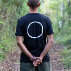 Close‑up of Plum Village Zen calligraphy 'Peace is Every Step' on a 100% organic cotton tee.