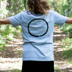Close‑up of Plum Village Zen calligraphy 'Respire' on a 100% organic cotton tee.