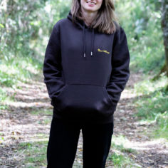 Person wearing a Plum Village Hoodie in a forest, highlighting 100% organic cotton - Wake Up