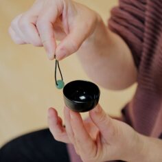 Compact miniature bell held in palm — pocket-sized meditation bell for practice on the go