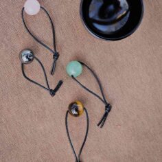Healing gemstones on miniature meditation bell — Carnelian, Hematite, Rose Quartz, Tiger's Eye
