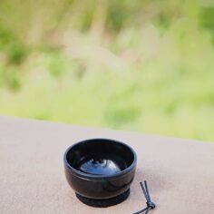 Mini bell for desk meditation — small Japanese mindfulness bell being invited to sound
