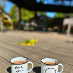 The Plum Village Enamel Mug, adorned with Thich Nhat Hanh’s “Drink your tea” calligraphy and the Enso Circle