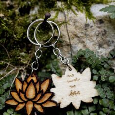 Plum Village Poplar Wood Keychain in lotus shape, laser-engraved with 'No Mud, No Lotus' quote.