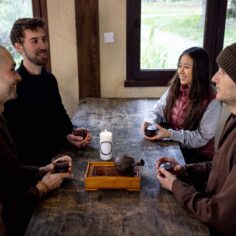 A cozy tea meditation setup with the Plum Village Tea Glass resting on a wooden table