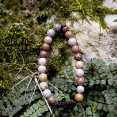 Jasper wrist mala close-up, showcasing 27 smooth wooden beads and a sleek adjustable string for a comfortable fit