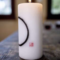 Close-up of the Zen Circle Calligraphy on the candle, symbolizing mindfulness and simplicity