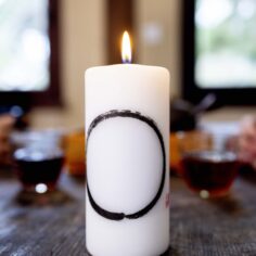 Close-up of the Zen Circle Calligraphy on the candle, symbolizing mindfulness and simplicity.